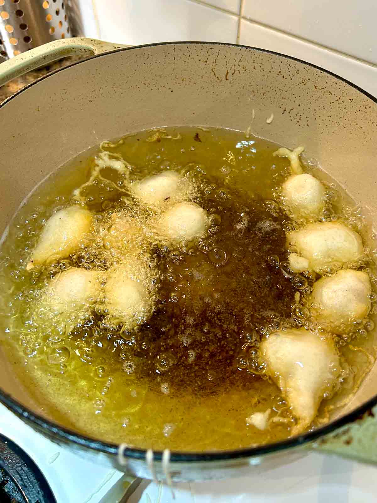 chicken balls puffing up initially when they are added to hot oil.