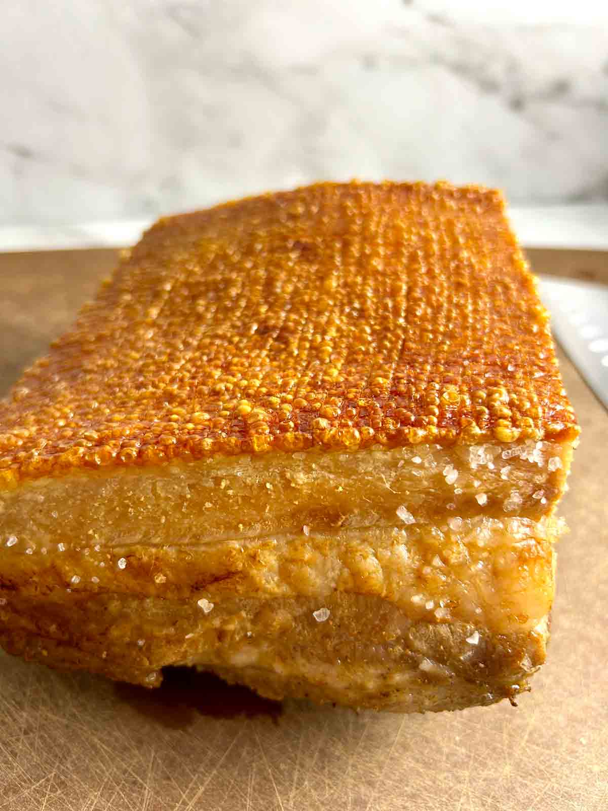 close up of crispy skin on roasted pork belly.