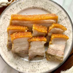 plate of crispy pork belly slices.