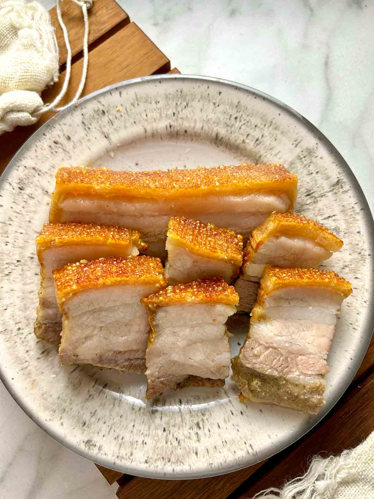 plate of crispy pork belly slices.