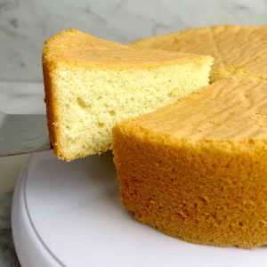 slice of sponge cake being lifted from cake.