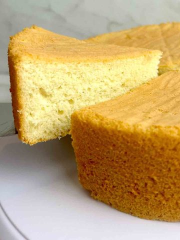 slice of sponge cake being lifted from cake.