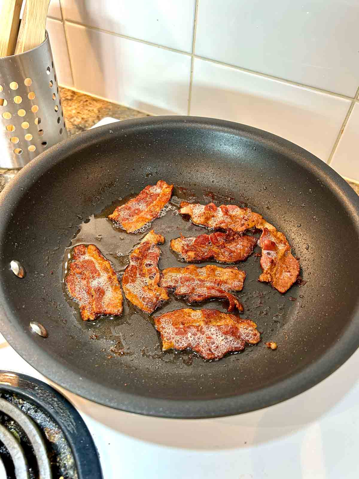 brown and crispy bacon in nonstick pan.