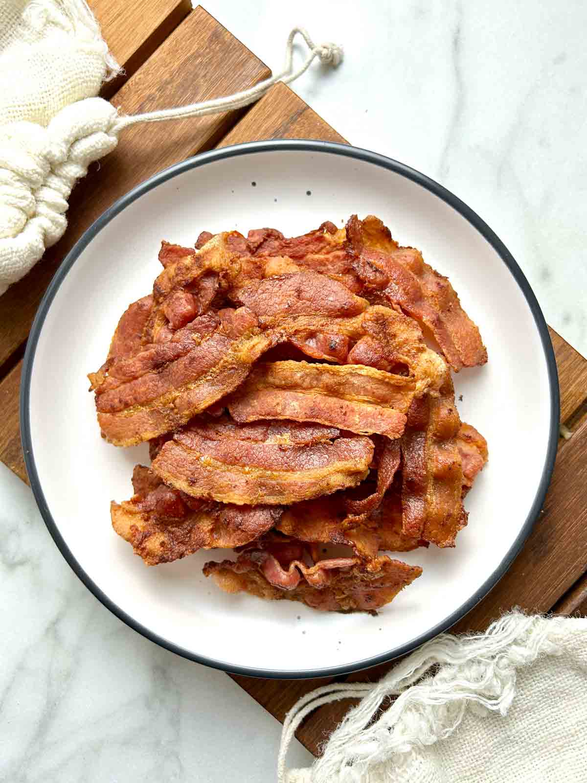 pile of crispy bacon strips on plate.