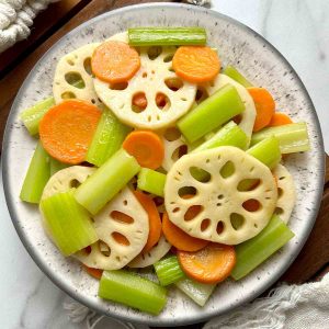 lotus root, carrot, and celery stir fry on plate.