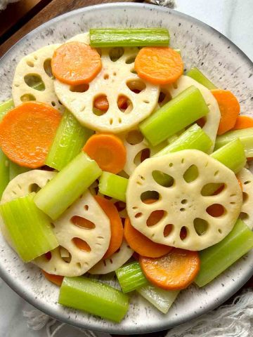 lotus root, carrot, and celery stir fry on plate.