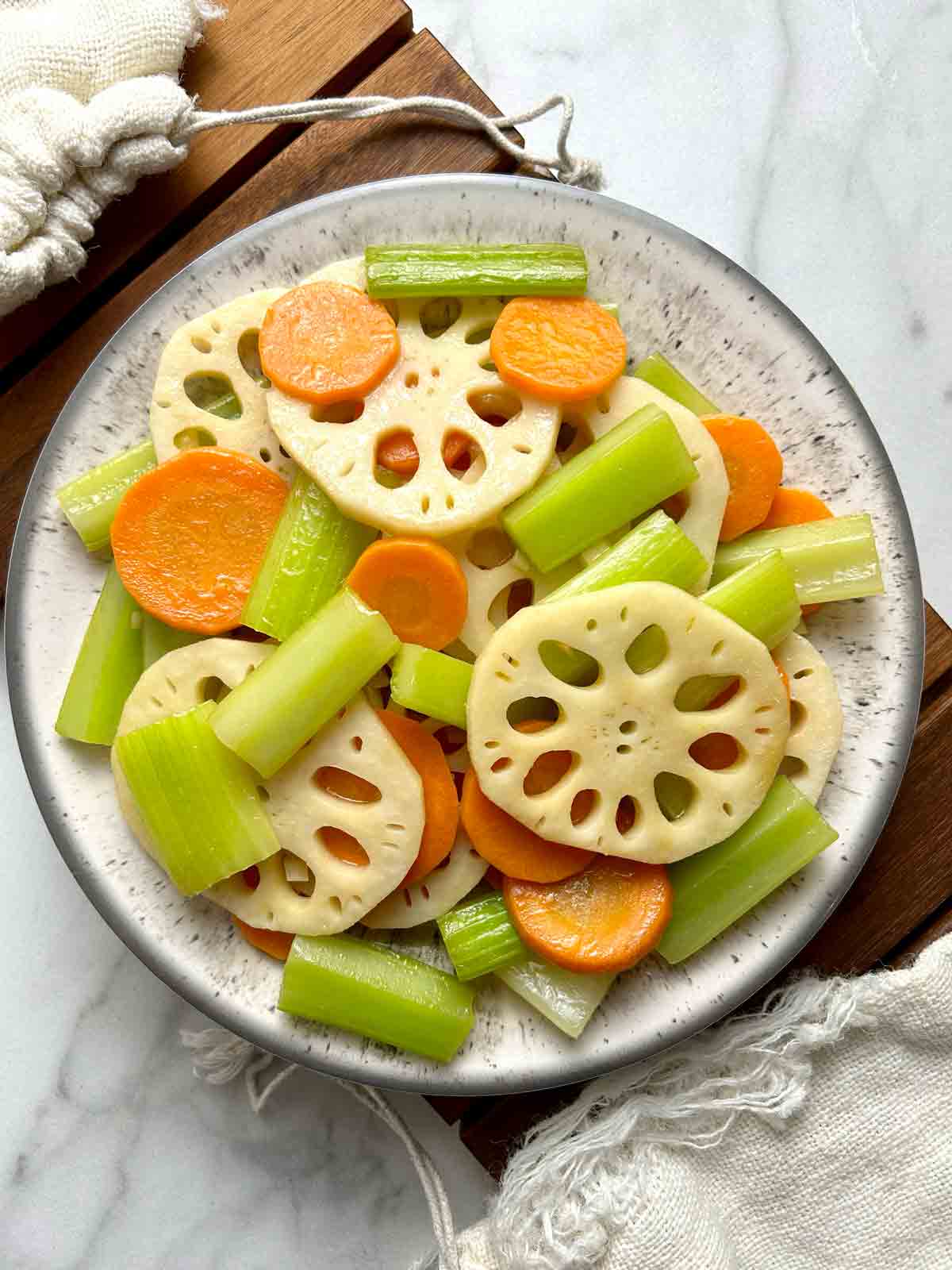 lotus root, carrot, and celery stir fry on plate.