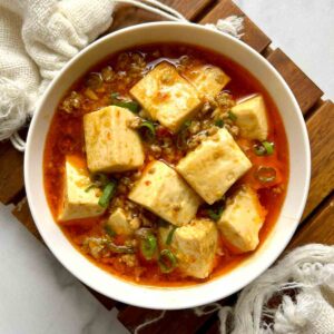 overhead shot of mapo tofu in small bowl.