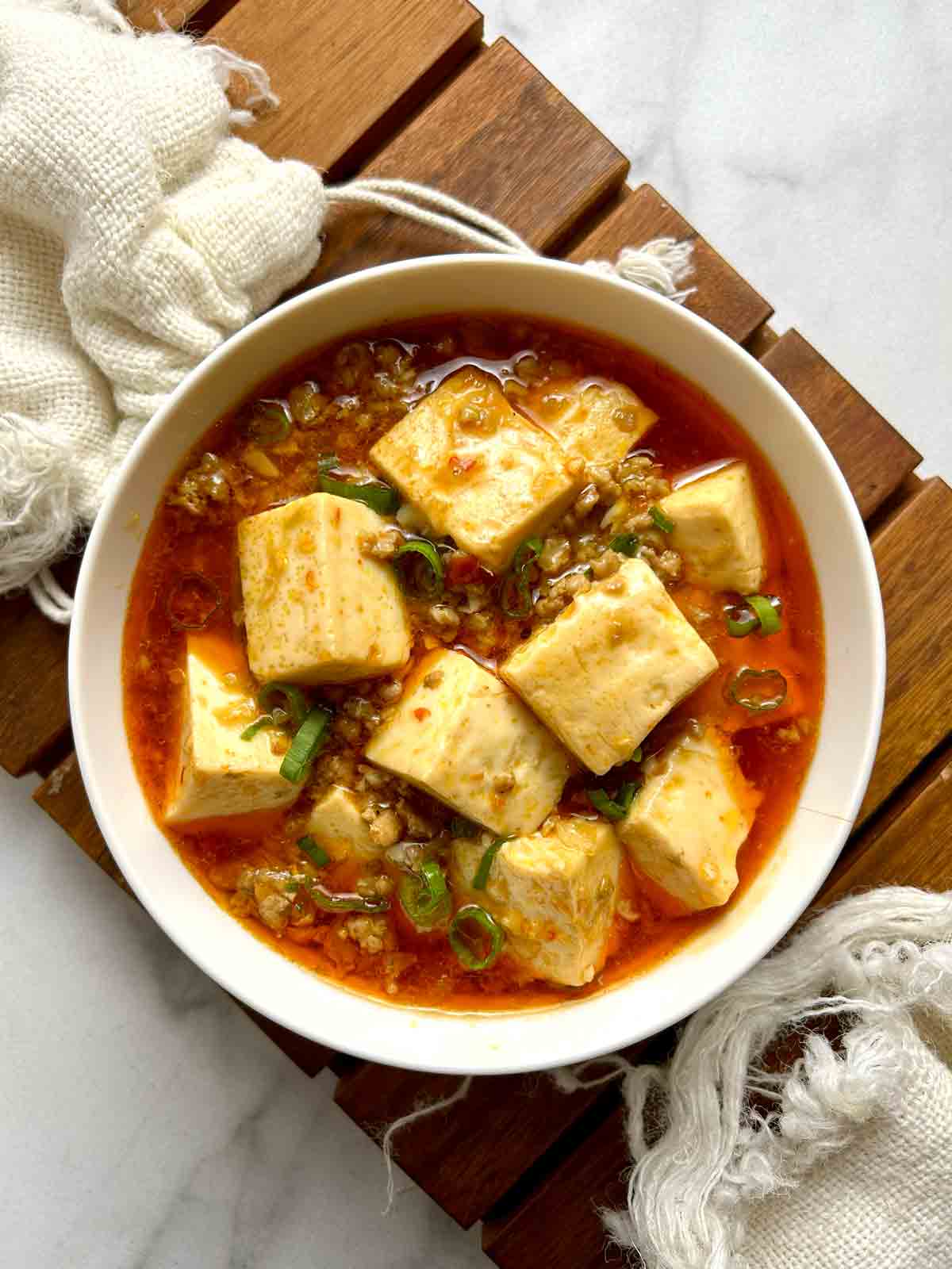 overhead shot of mapo tofu in small bowl.