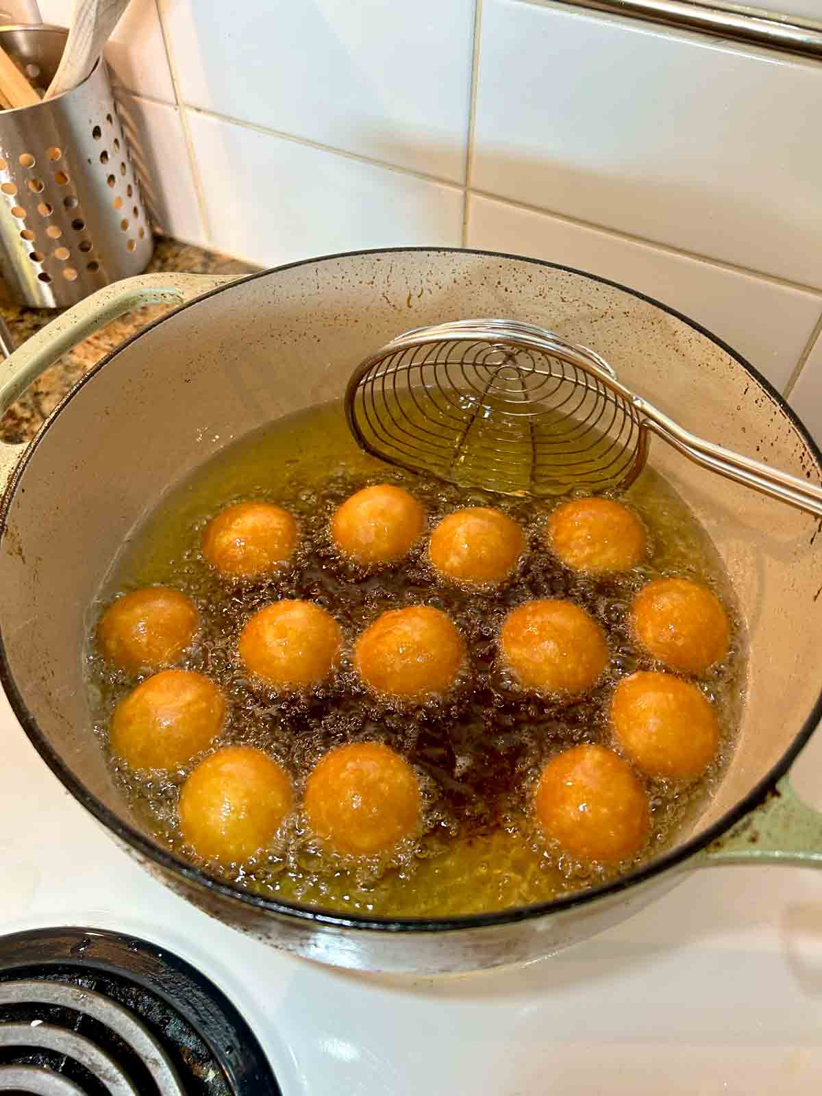 mochi donut holes frying in hot oil.