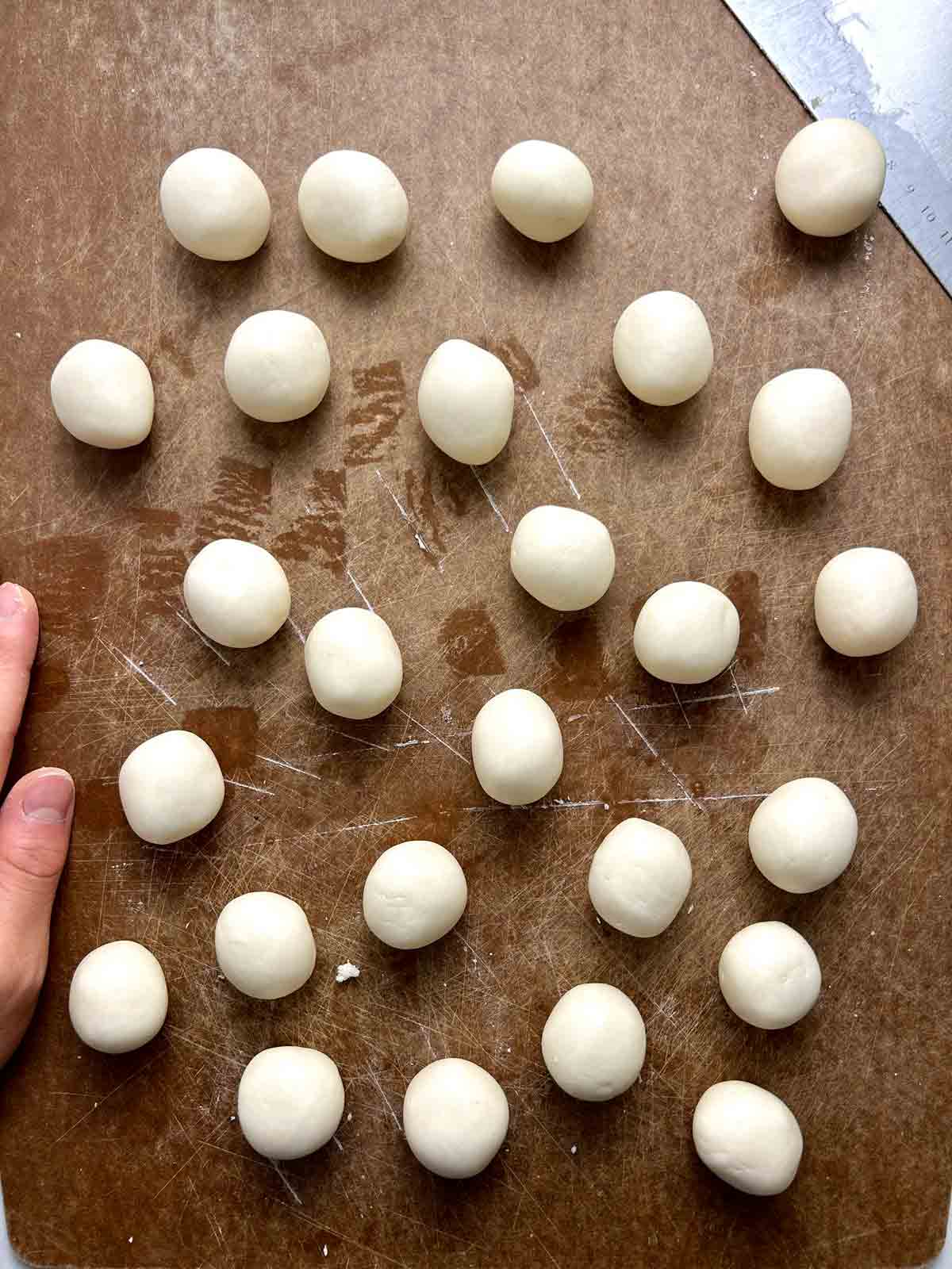 dough pieces rolled into smooth balls.