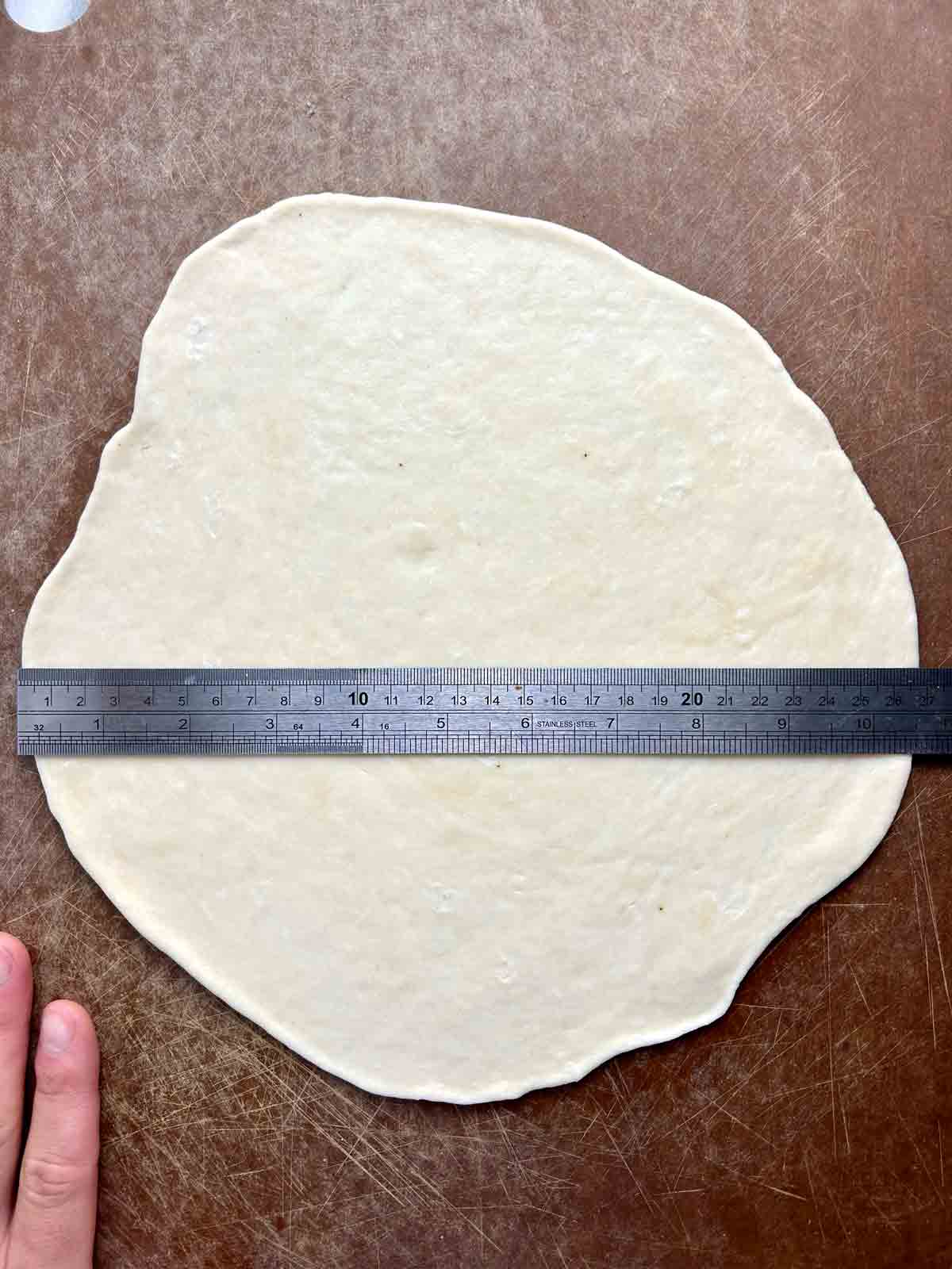 rolled out dough measuring 10 inches on a ruler.