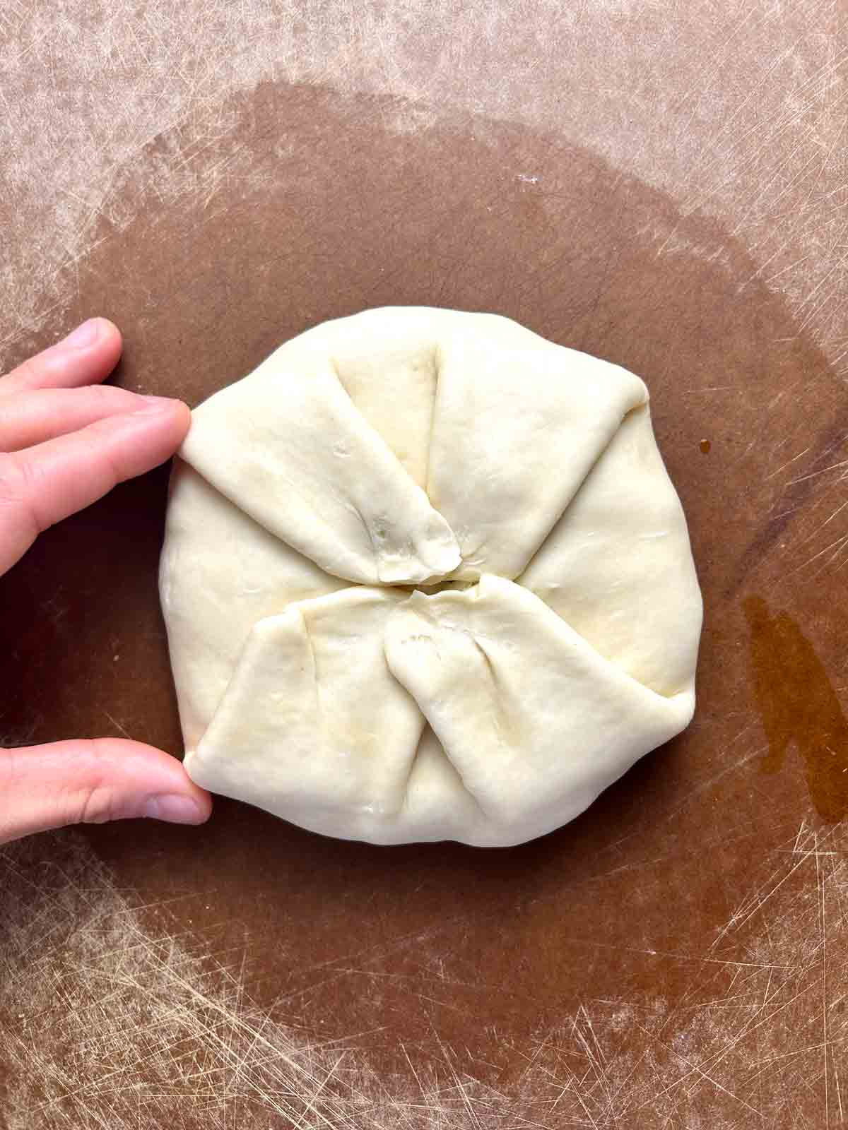 edges of dough pulled up over the filling.