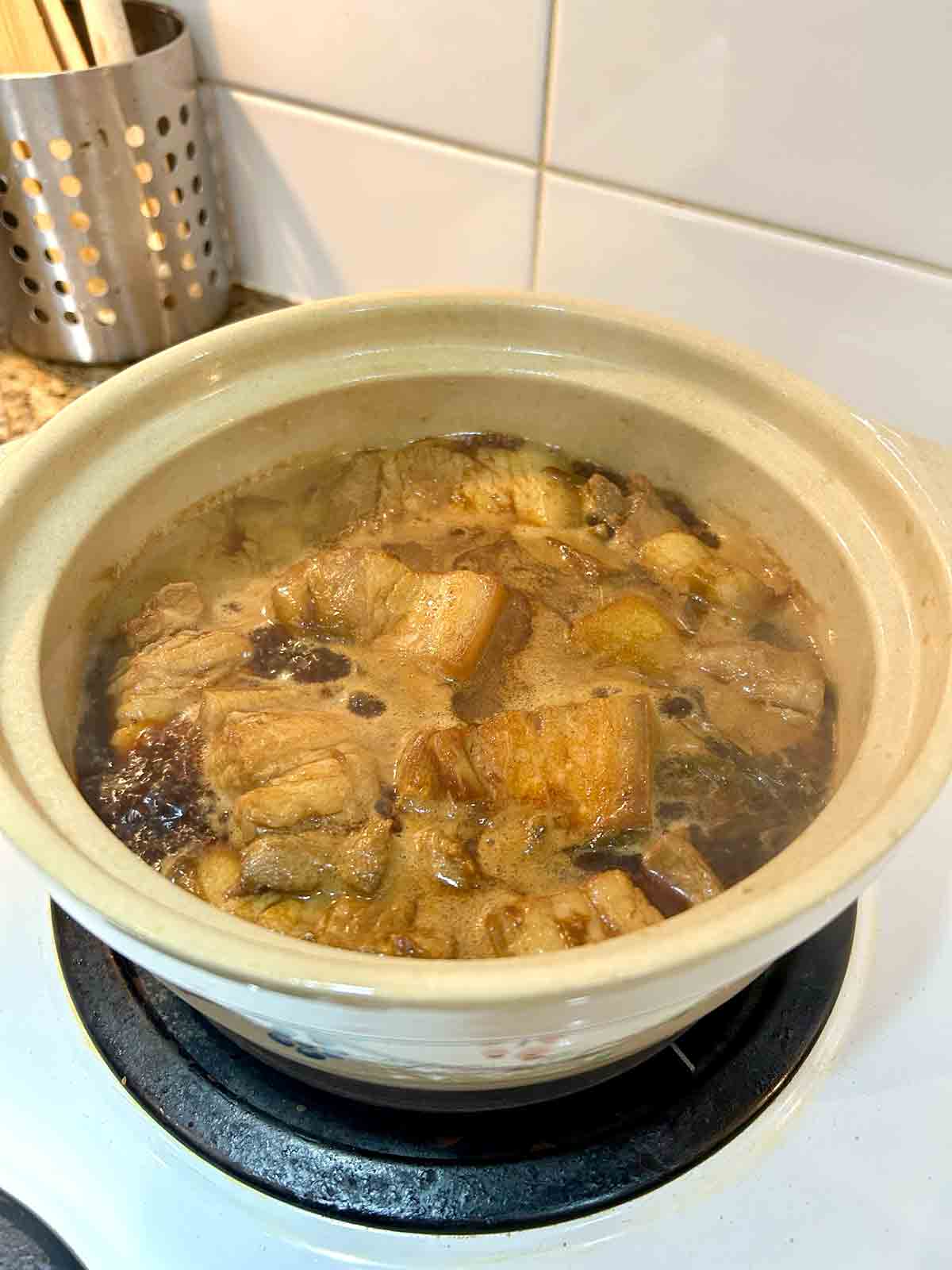 pork belly braising in clay pot.