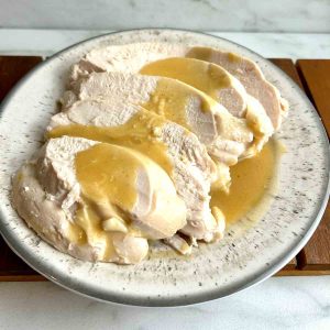 sliced turkey breasts with gravy poured on top.