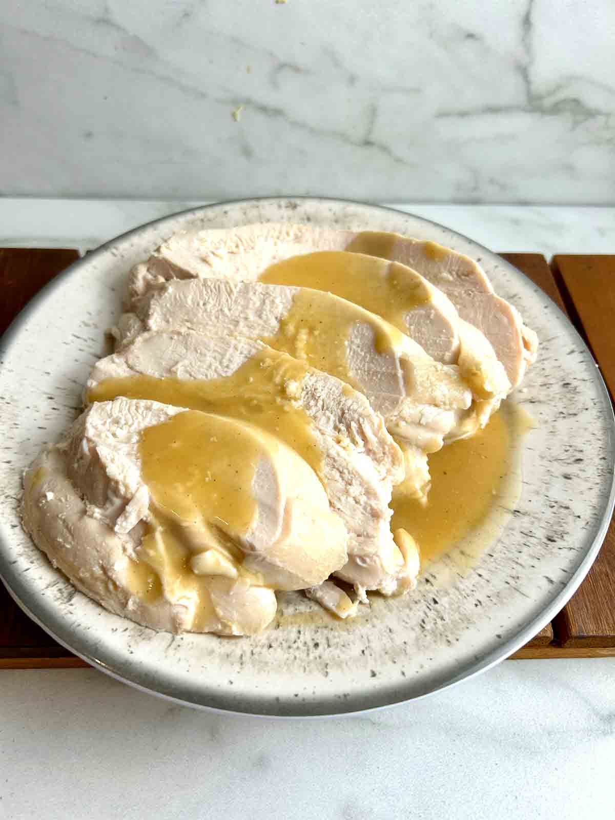 sliced turkey breasts with gravy poured on top.