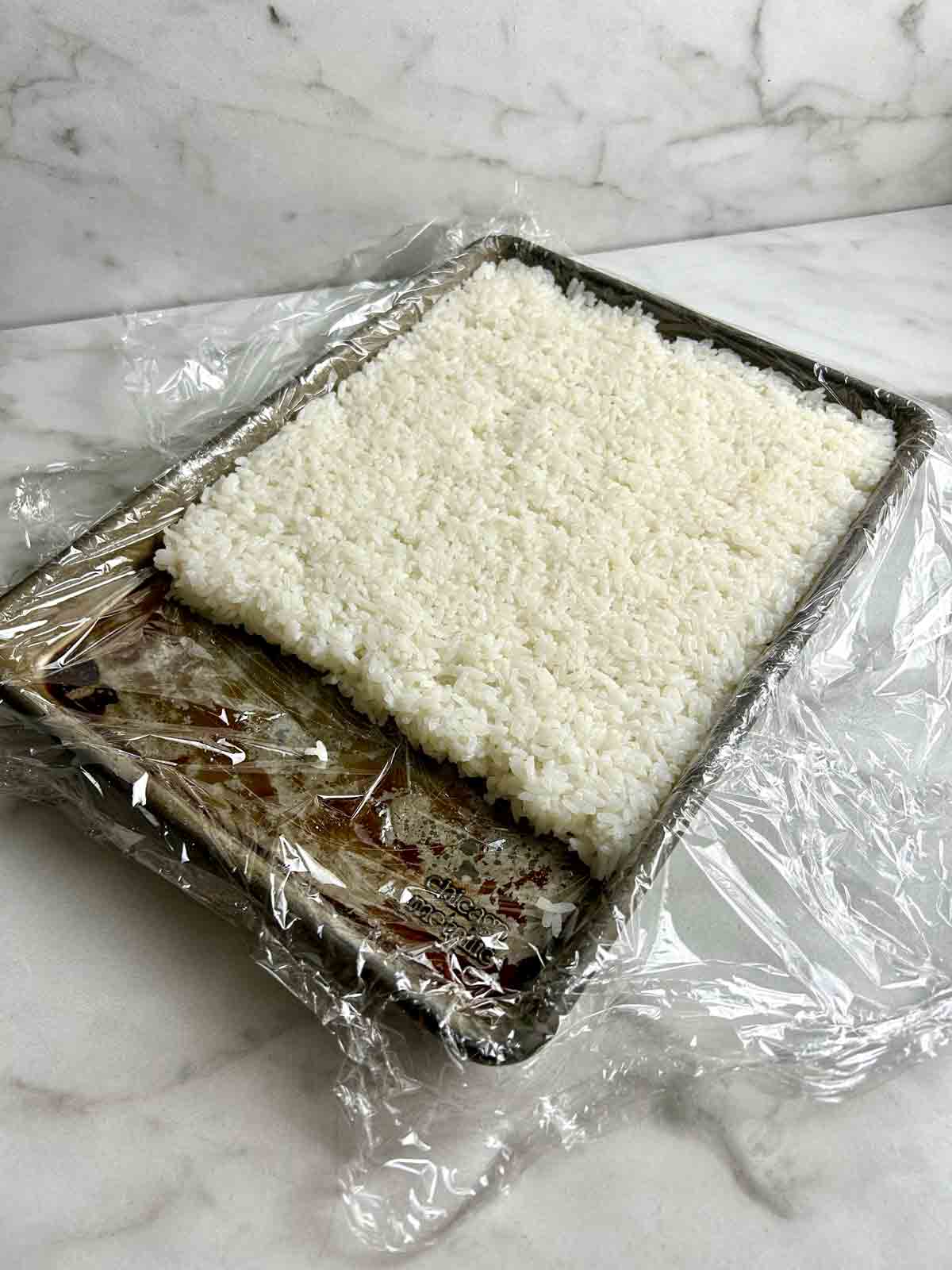 rice pressed into ½ inch thick rectangle in baking pan lined with plastic wrap.