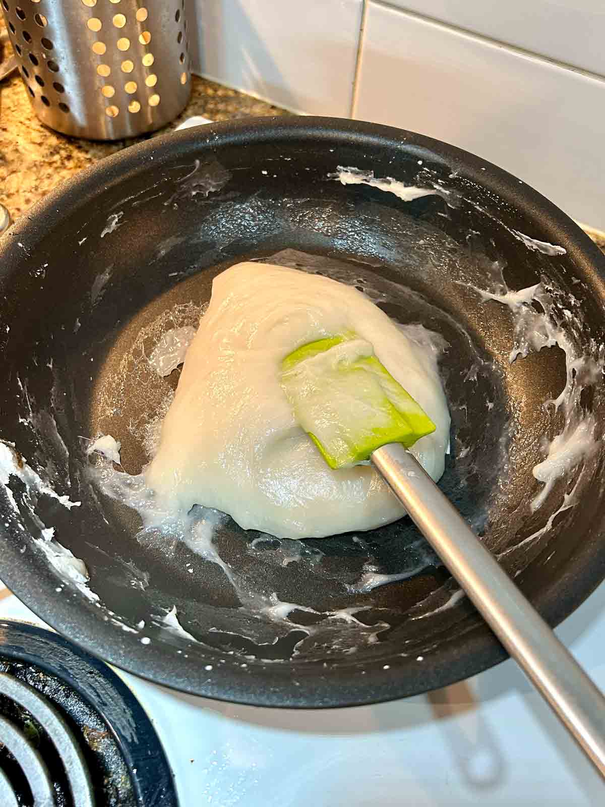 mochi dough being cooked in nonstick pan.