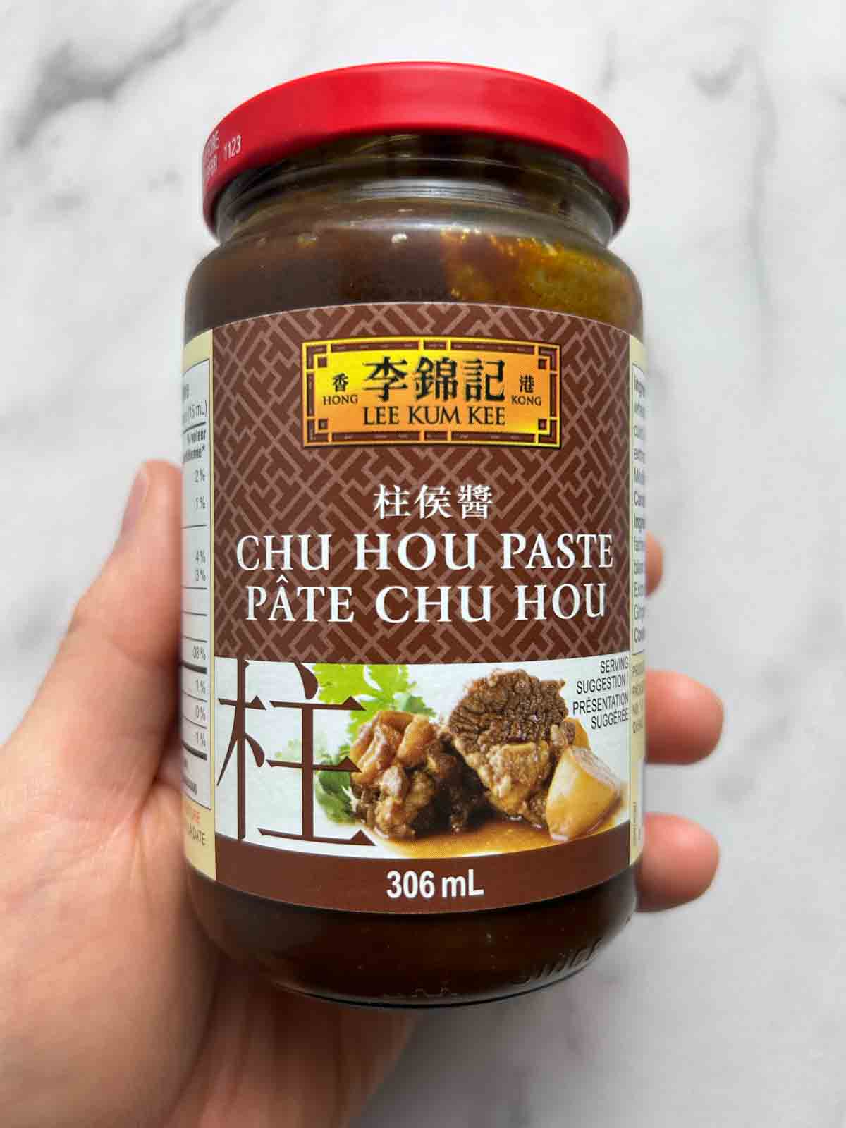 hand holding jar of chu hou paste.