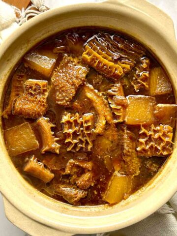 overhead shot of braised beef tripe in clay pot.