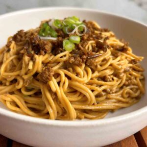 close up of dan dan noodles in bowl.