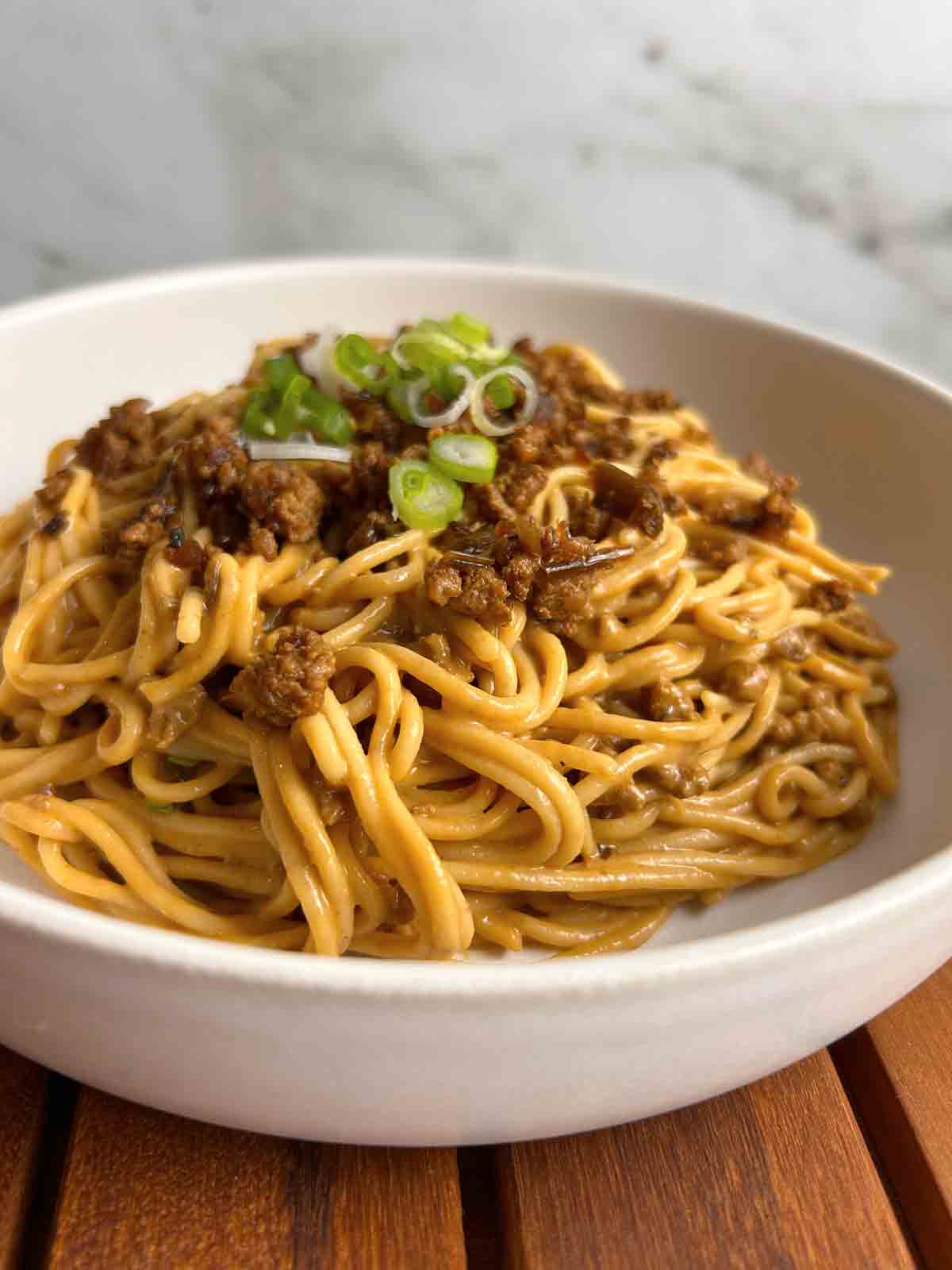 close up of dan dan noodles in bowl.