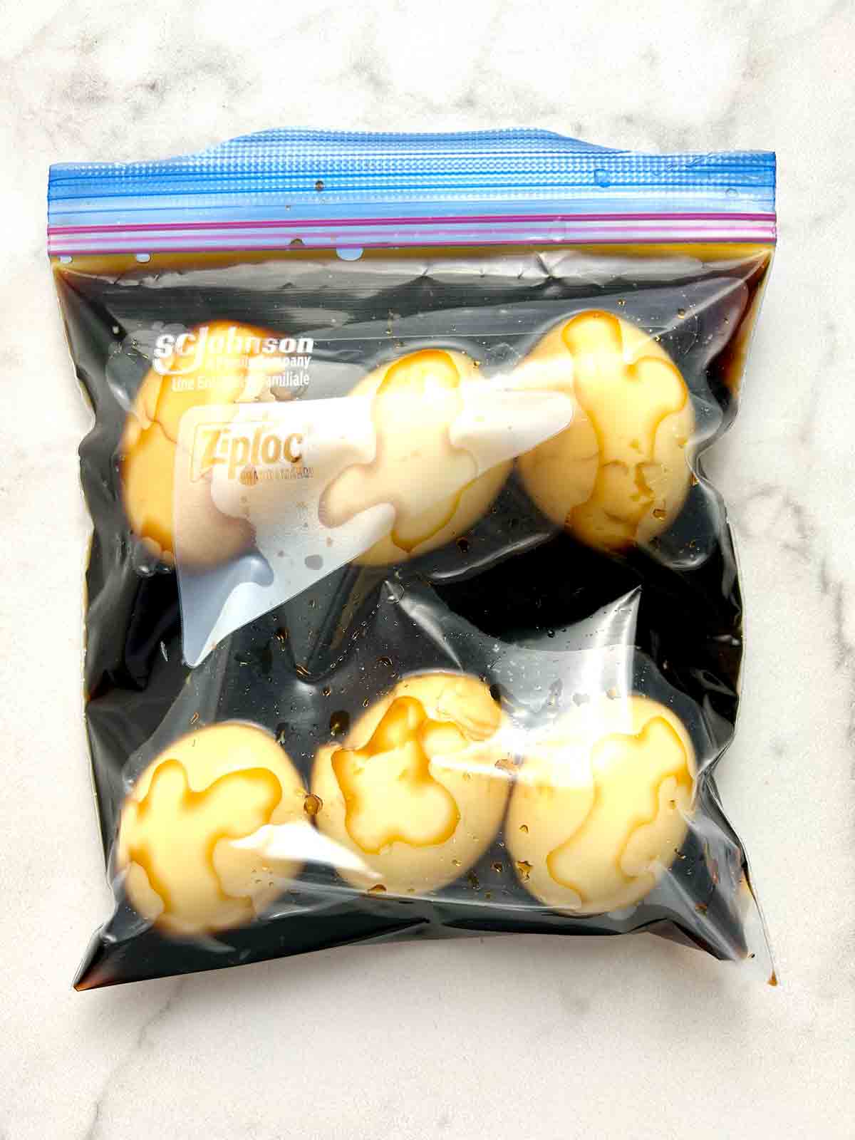 cooked eggs marinating in bag.
