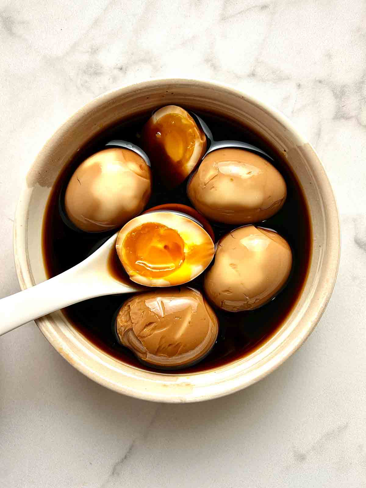 overhead shot of ramen eggs in bowl.