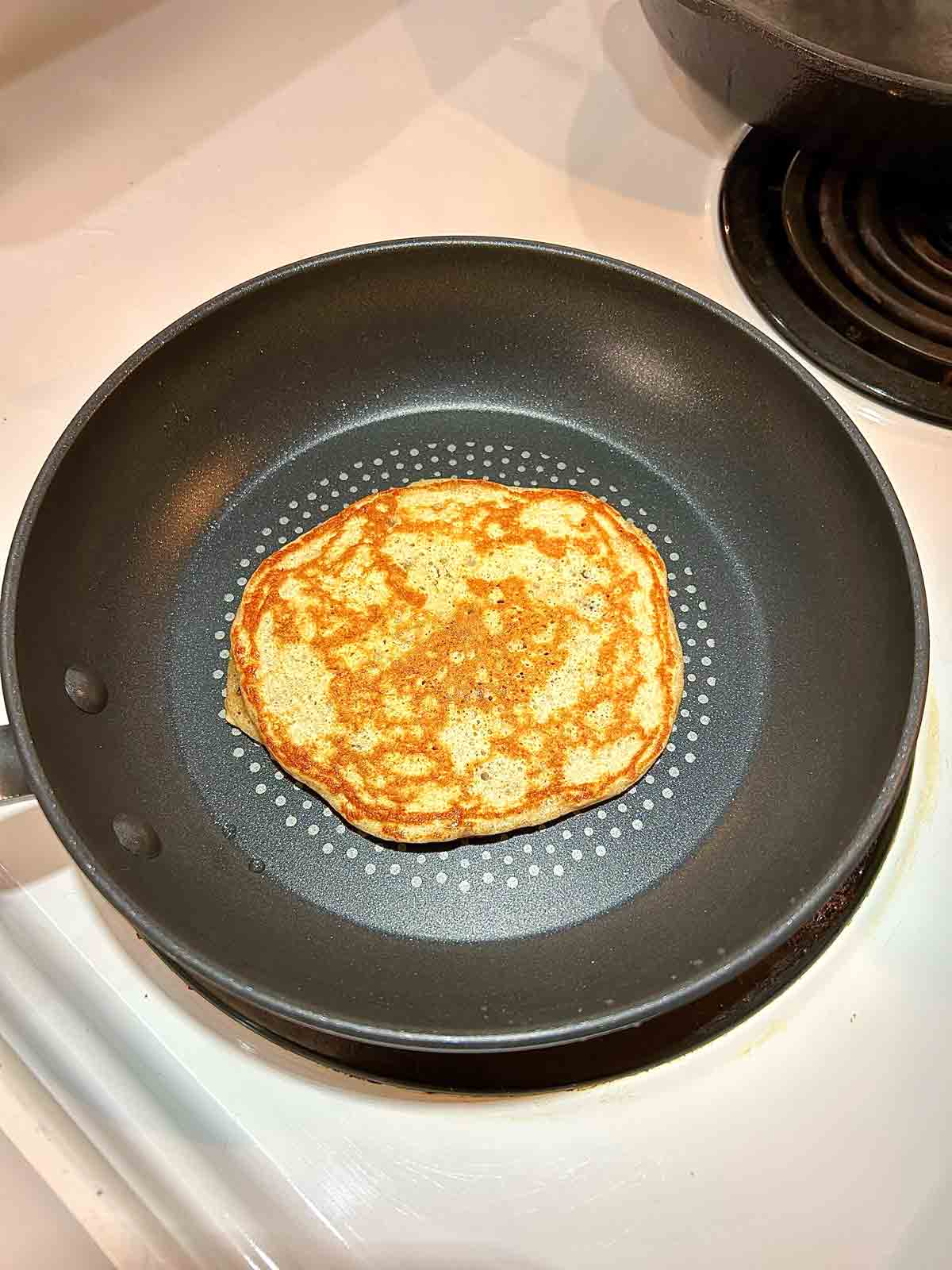 pancake cooking in pan.