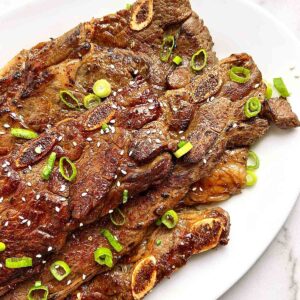 close up of grilled Korean beef short ribs on plate.