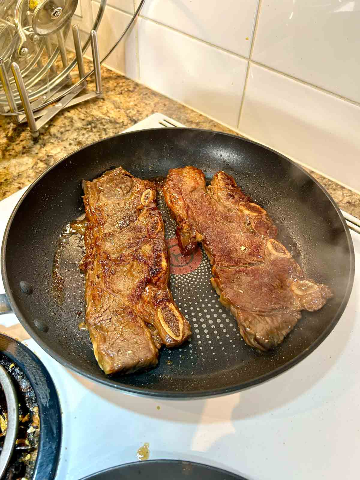 short ribs being grilled on pan.