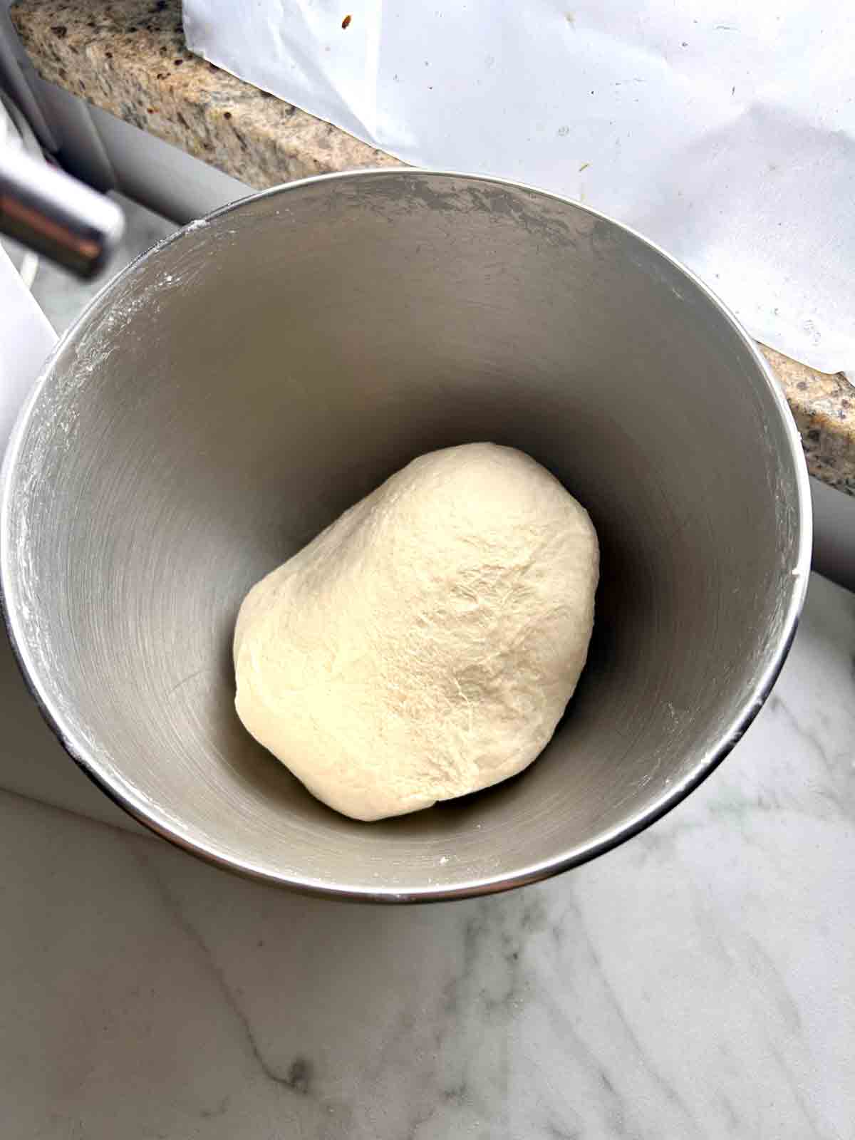 kneaded dough in stand mixer bowl.