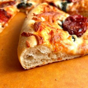 slice of pizza showing cross section of crust.