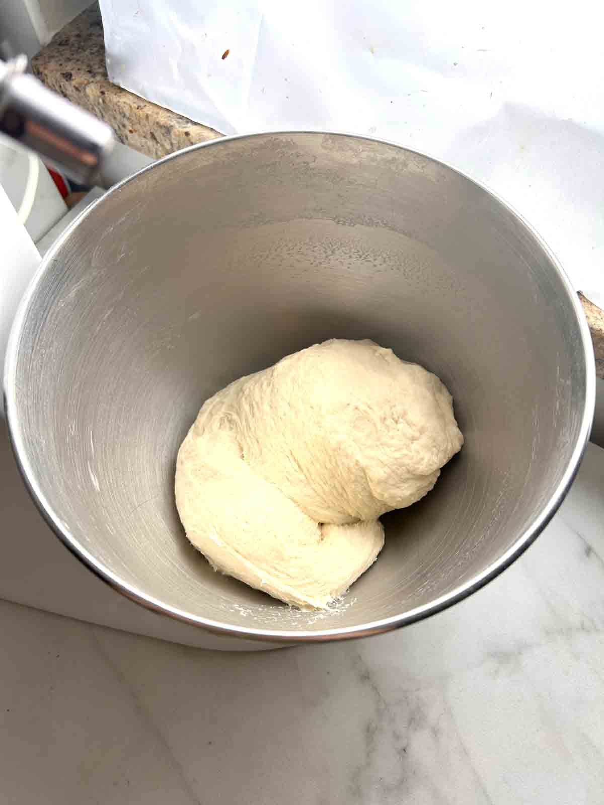 dough being kneaded in stand mixer.