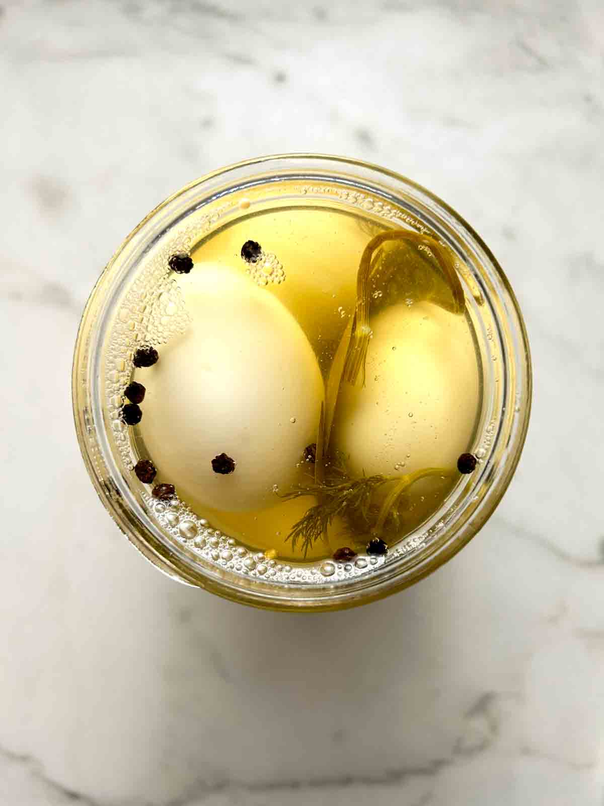 overhead shot of pickled eggs in jar.