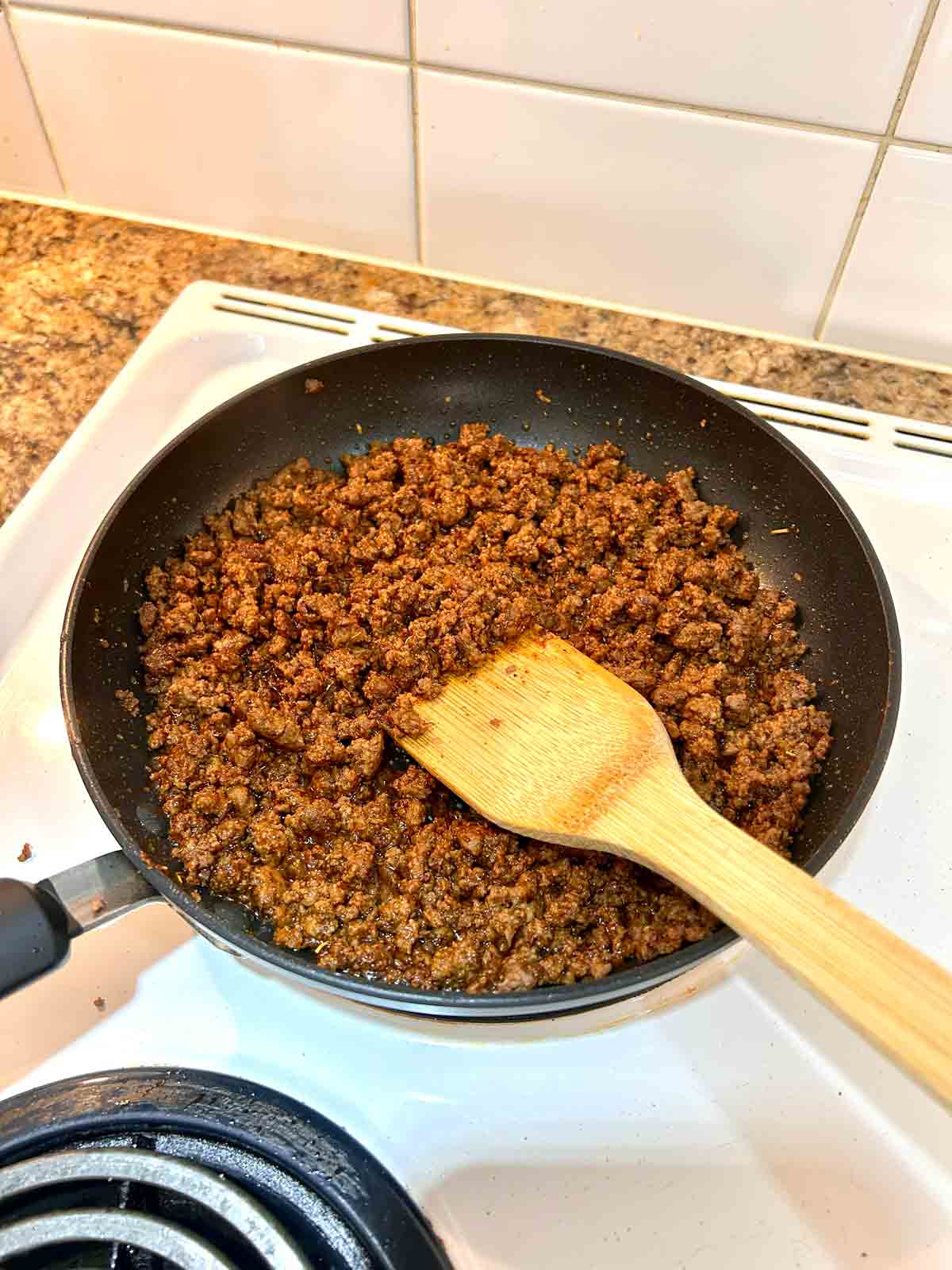 taco beef being cooked in pan.