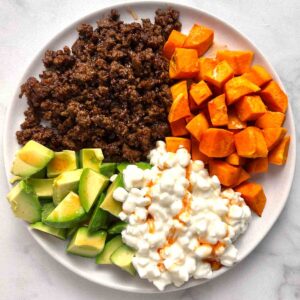 ground beef, avocado, sweet potatoes, and cottage cheese in bowl.