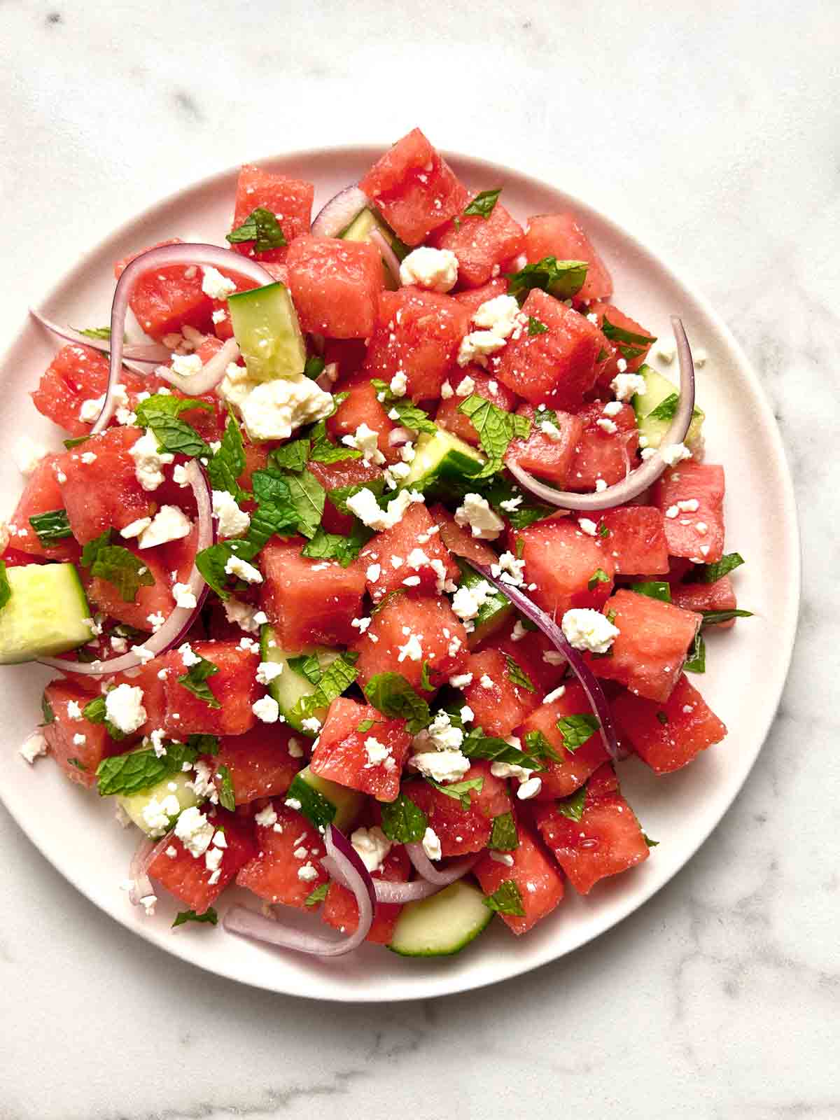 close up of watermelon salad on plate.