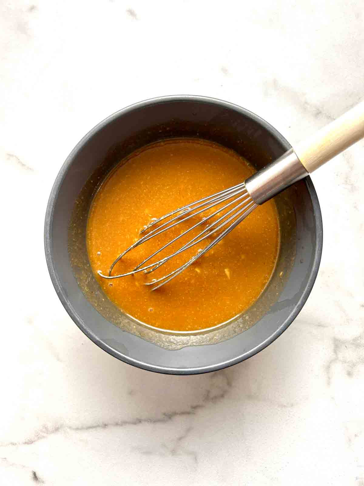 peanut dressing whisked in bowl.