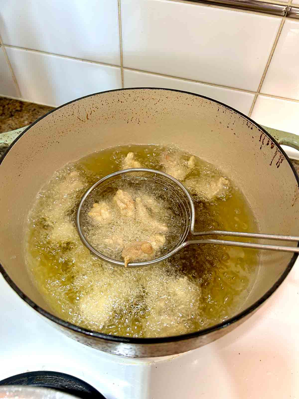 chicken being deep-fried.