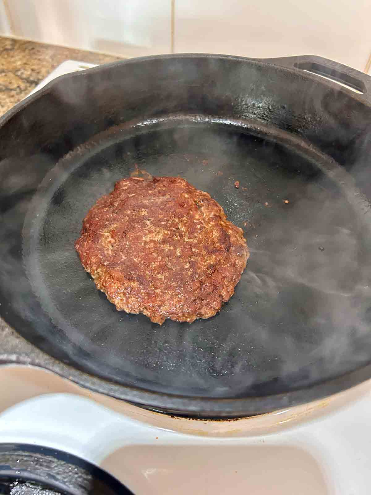 patty flipped over to show crispy, browned side.