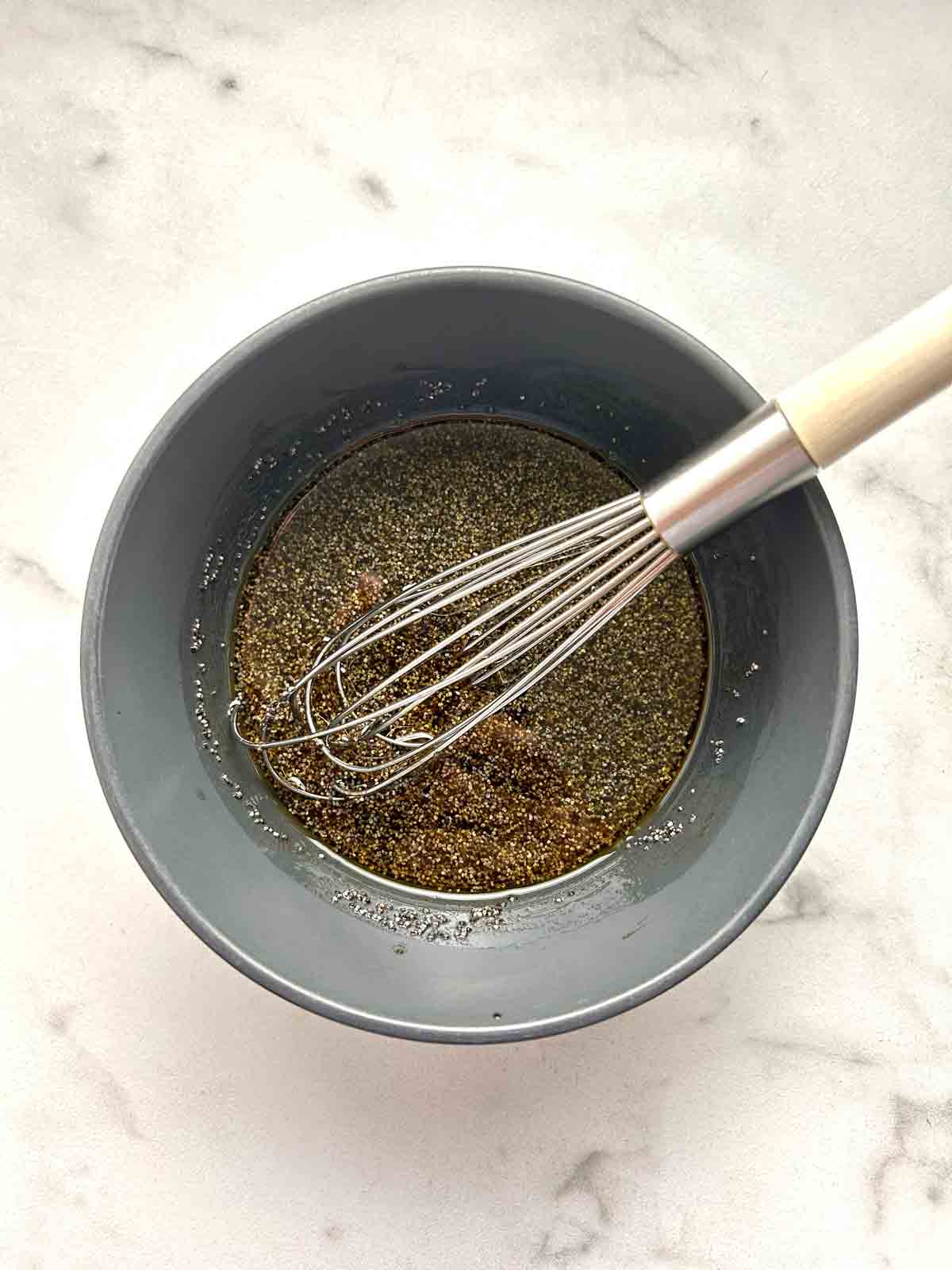 poppyseed dressing whisked in bowl.
