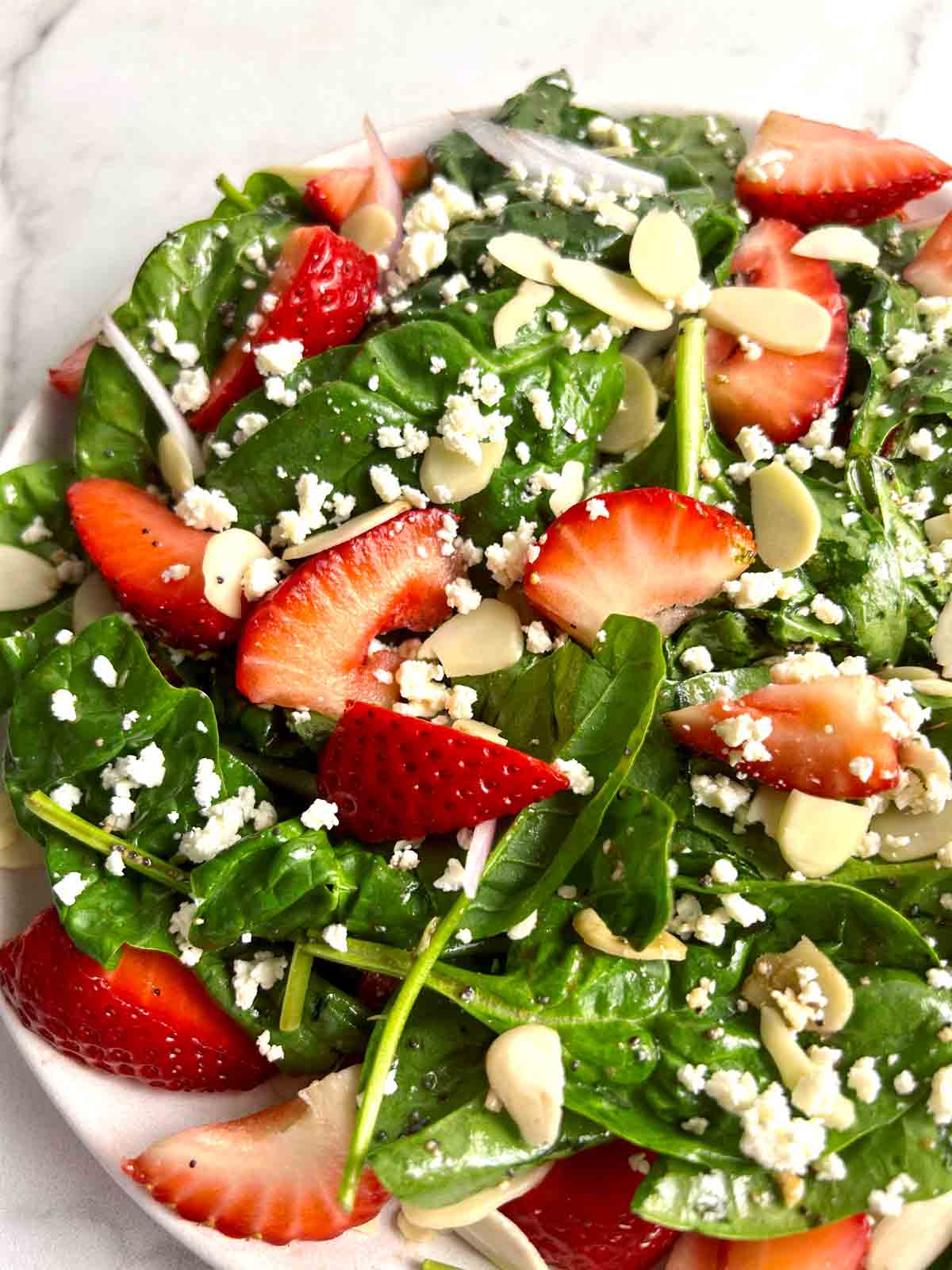 close up of strawberry spinach salad on plate.