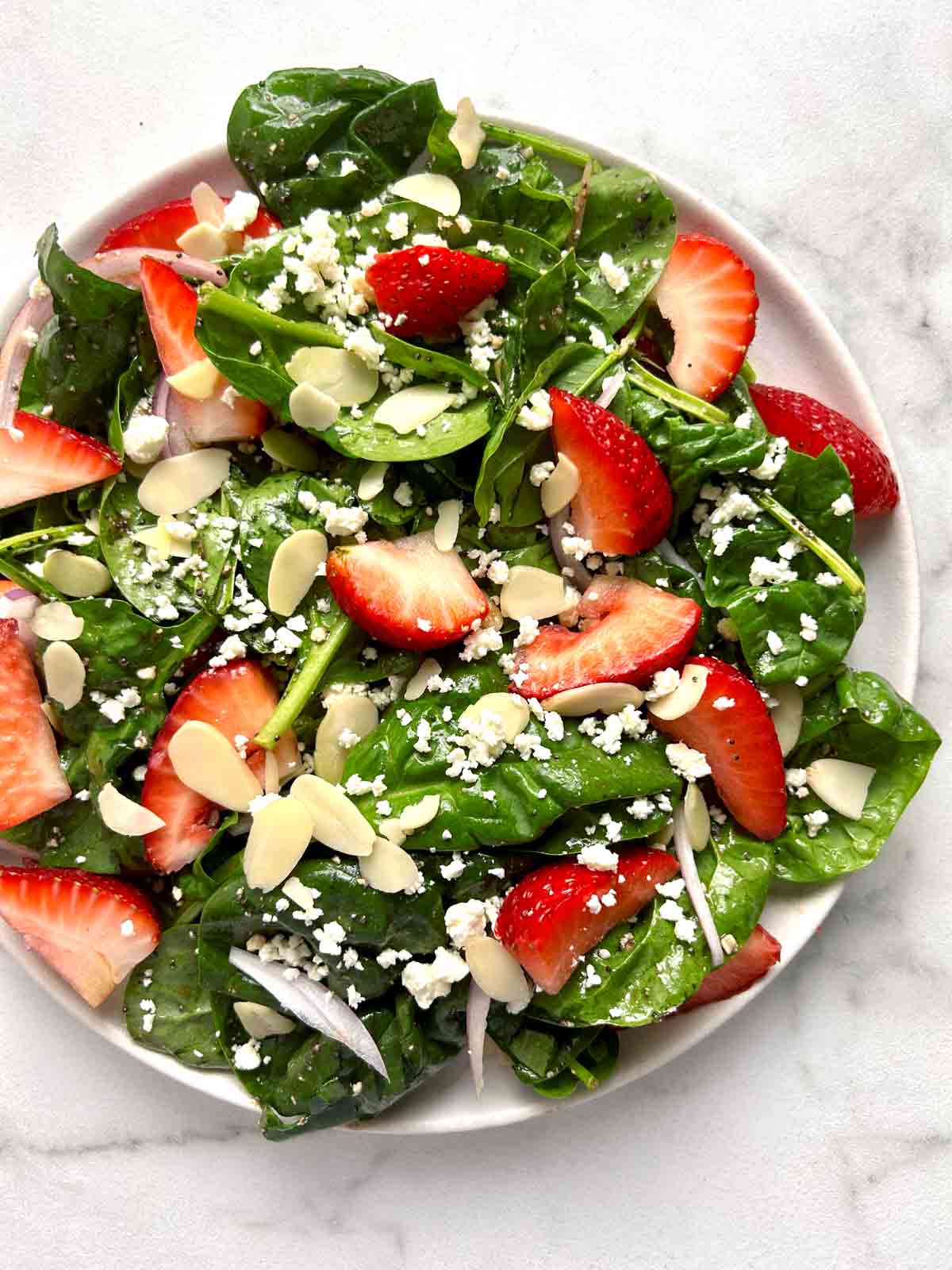 strawberry spinach salad on plate.