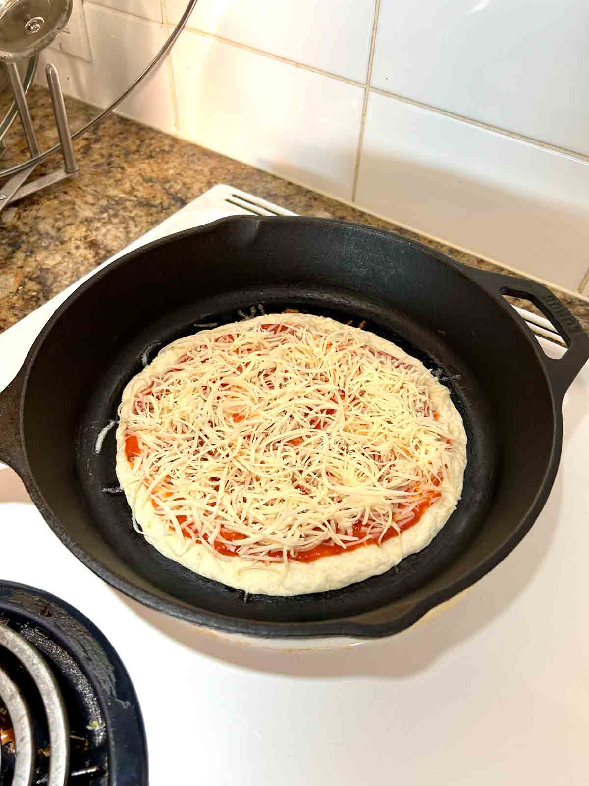 add cheese to pizza.