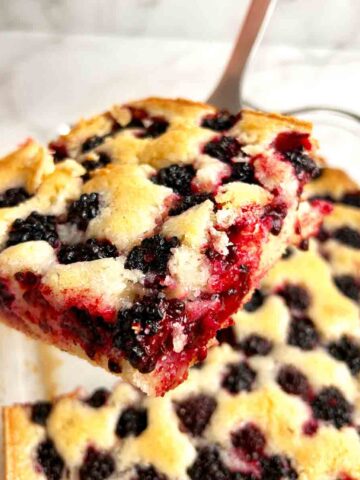spatula lifting slice of cobbler from baking dish.