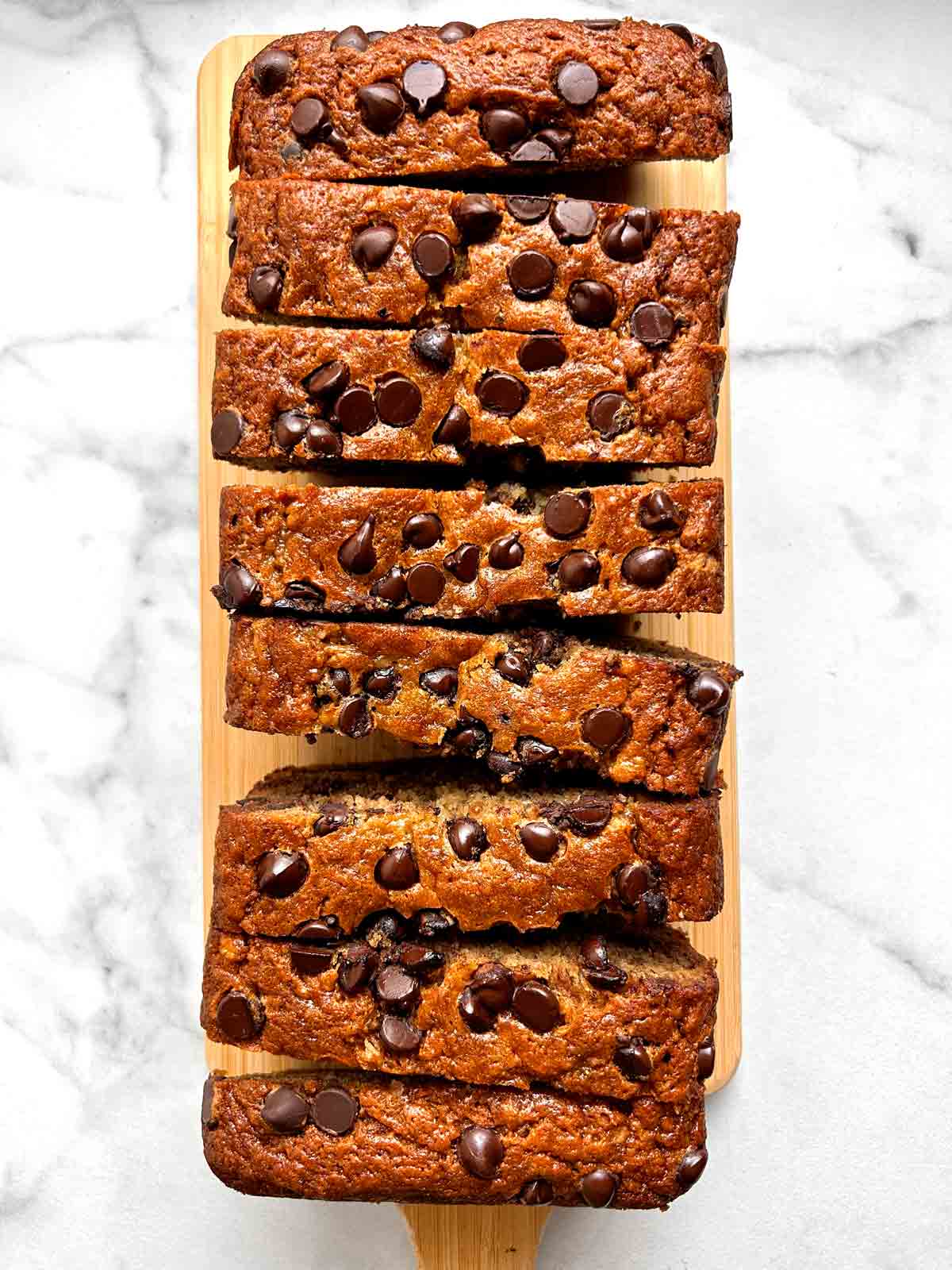 overhead shot of chocolate chip banana bread sliced into many pieces.