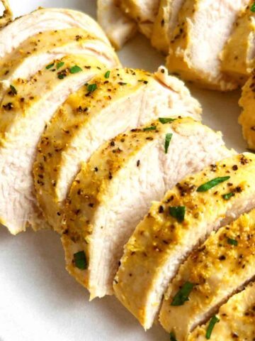 close up of sliced lemon pepper chicken breasts.