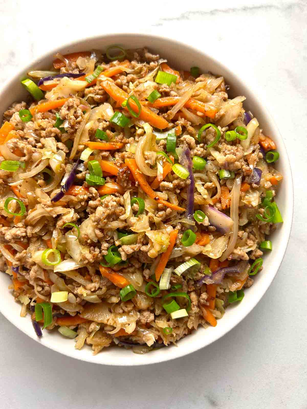 close up of egg roll in a bowl.