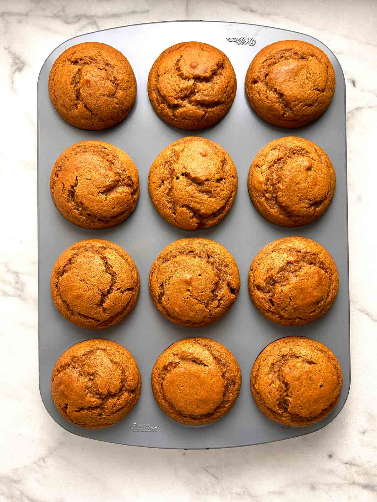 pumpkin muffins after baking; still in muffin tray.